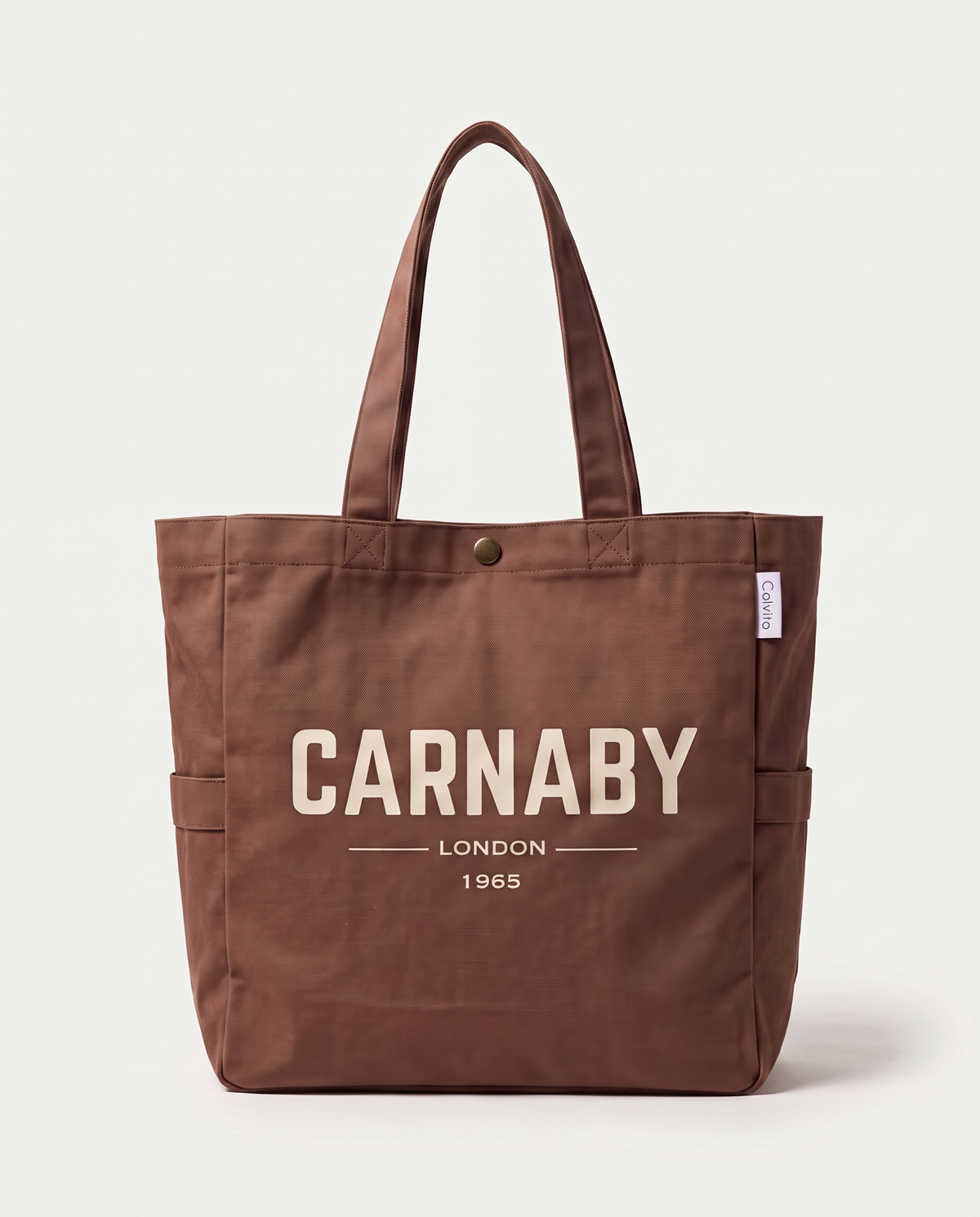 CARNABY LONDON 1965 canvas tote bag in brown, front view with brass snap button and side pocket